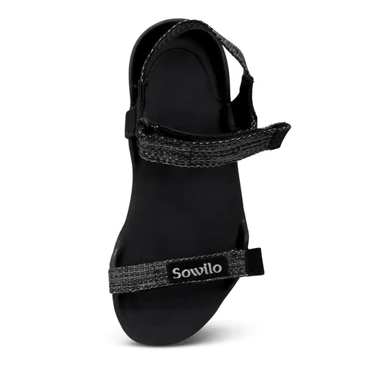 Sandalia Sowilo Raido negra vista frontal mostrando estructura plana barefoot.