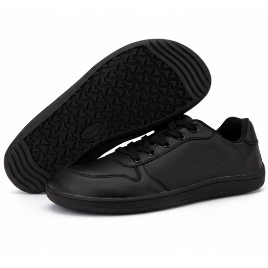 Suela de goma negra plana con patrón de tracción geométrico.