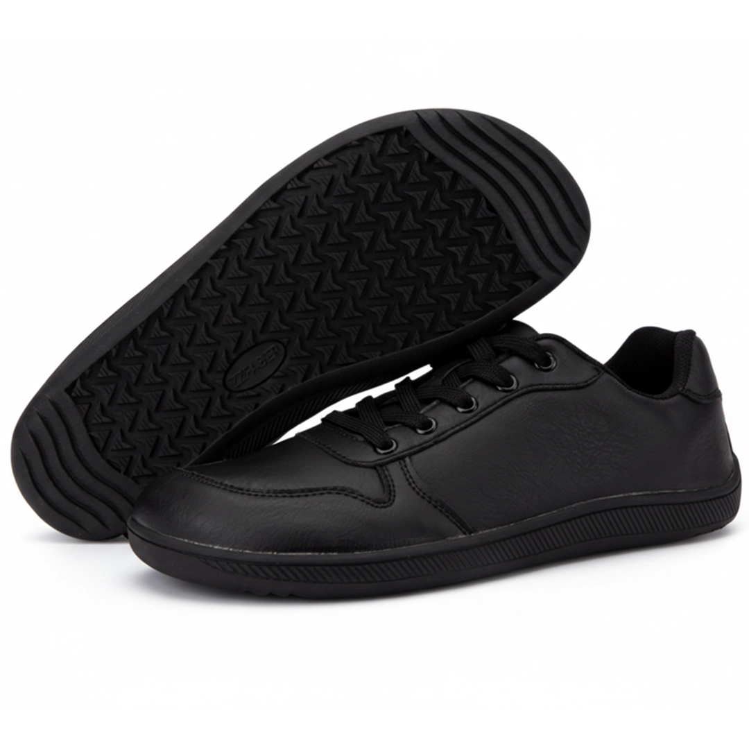 Suela de goma negra plana con patrón de tracción geométrico.