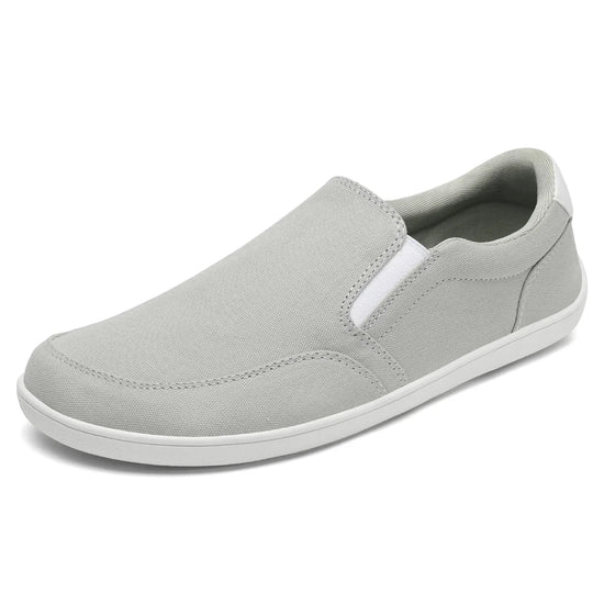 Zapatilla casual sin cordones gris, estilo minimalista y ligero.