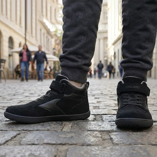 Niño usando zapatillas barefoot negras, caminando libremente por la ciudad. 