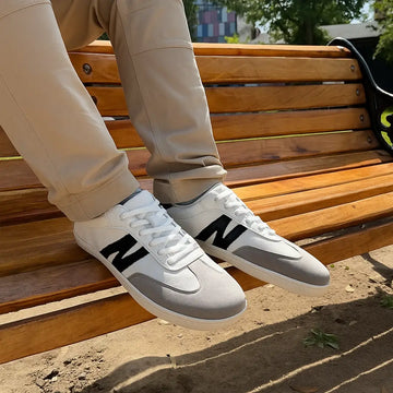 Persona usando zapatillas ZZfaber Niza I blanco con negro en exterior.