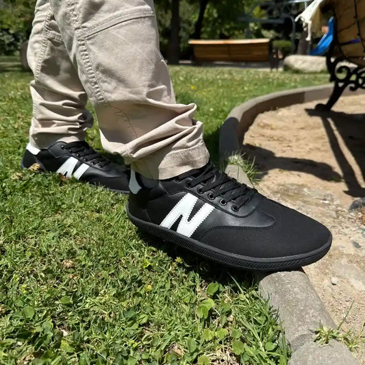 Persona usando zapatillas ZZfaber Niza I negras con blanco en exterior.